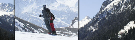 Mountain ranges with close up shot of two skiers
